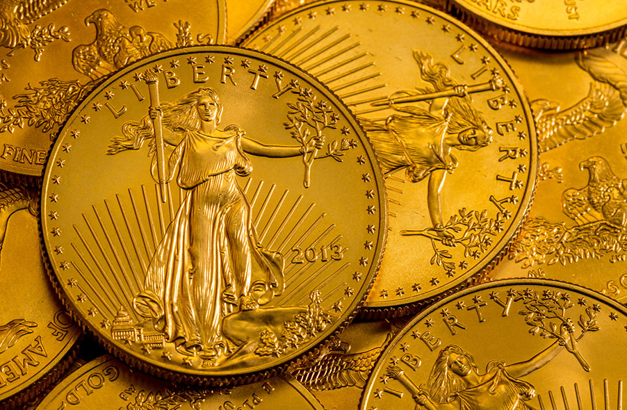 pile of gold coins including american gold eagle