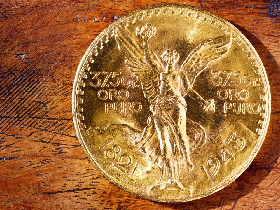 a mexican gold coin in a wooden table