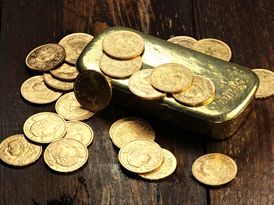 gold coins stacked with several coins around it