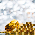 stack of gold coins and gold bars with bright background