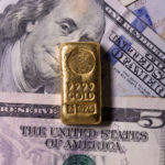 gold bar on us dollar note