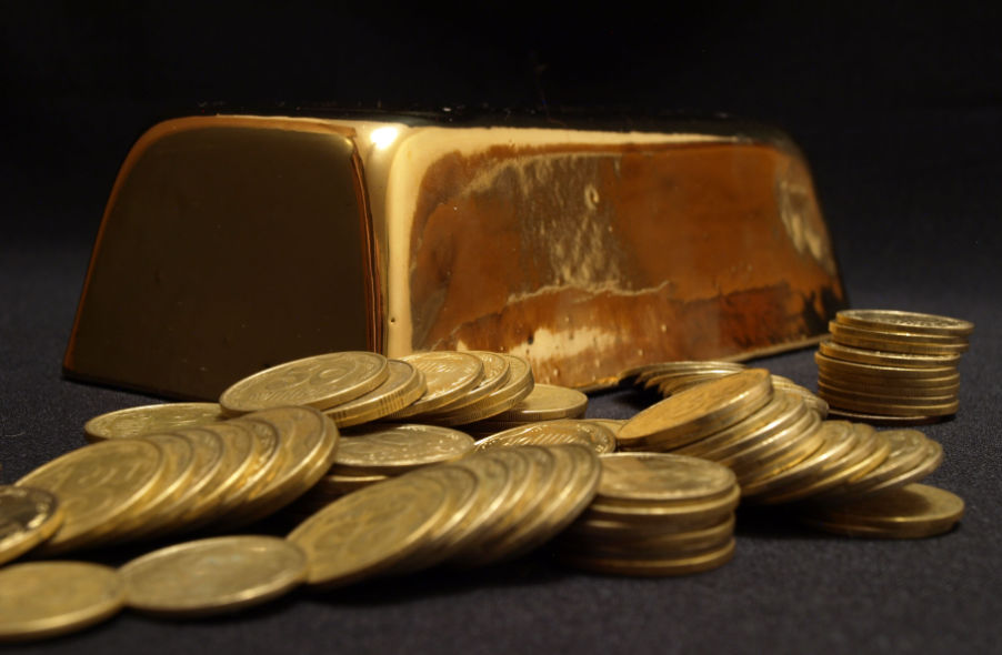 one kilo of gold bar and pile of gold coins