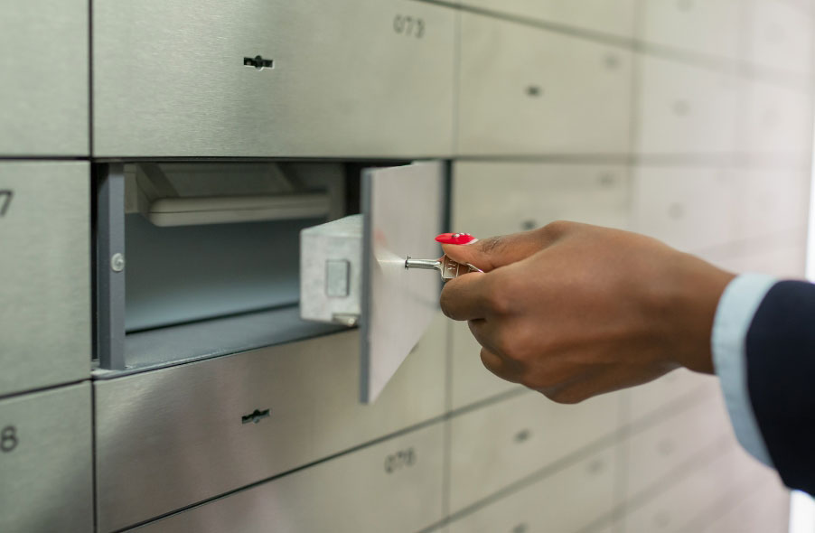 employee opening safety deposit box