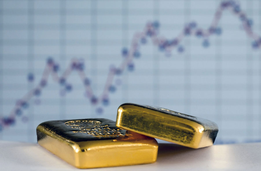 two gold bars on the background of gold price chart