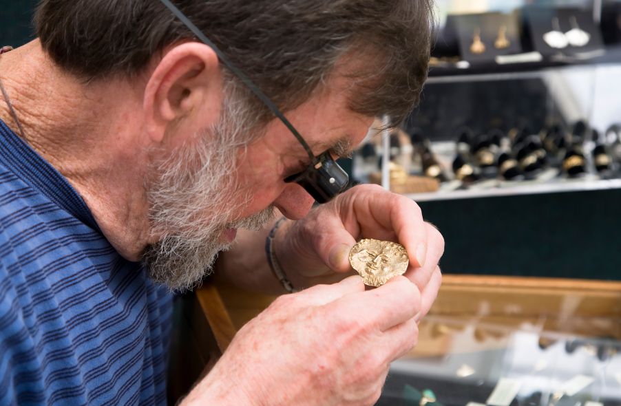 expert jewelry appraiser checking quality of gold