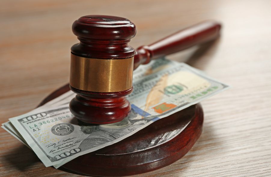 gavel with dollar banknotes on table