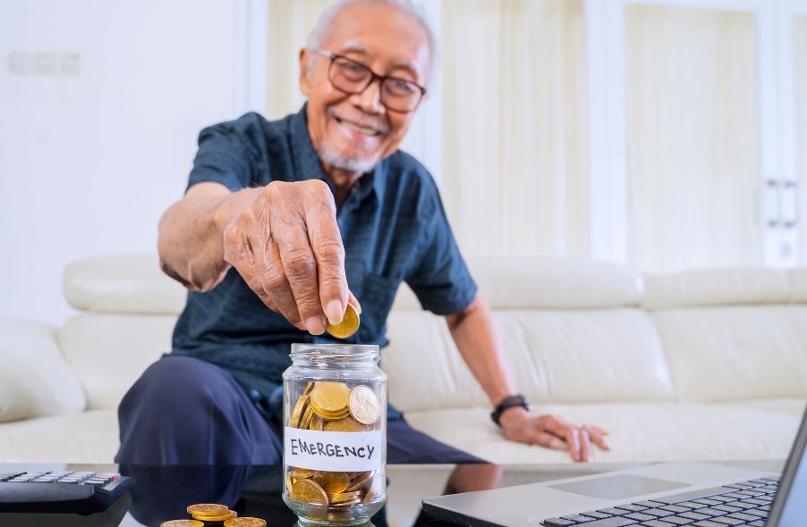 old man saving coins in jar